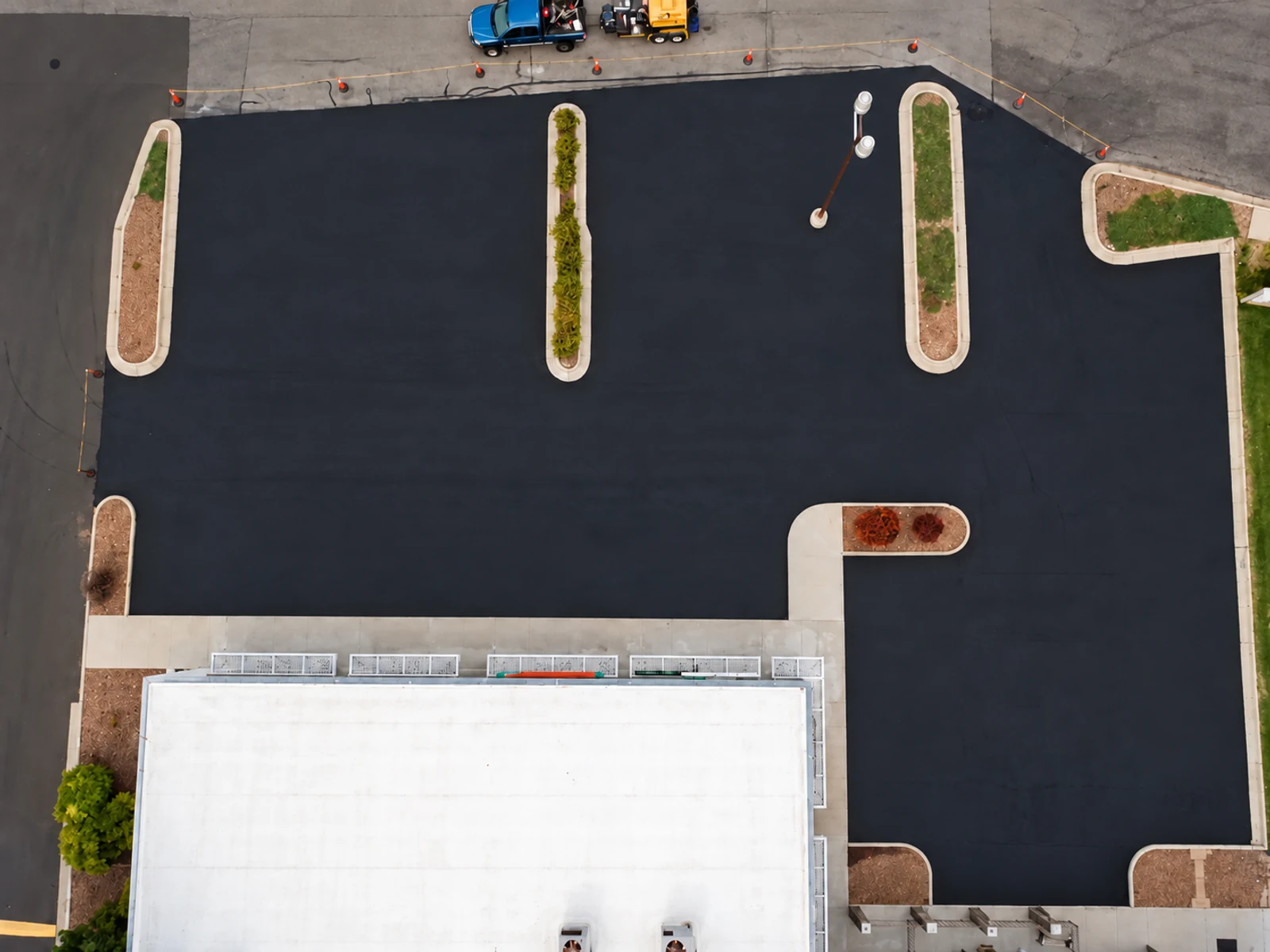 Before line striping: the same parking lot with faded pavement markings.
